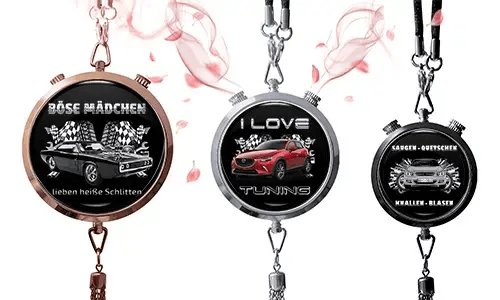 Three round pendants with car themes on black backgrounds. Left: vintage car with German text and checkered flags. Center: red SUV, 