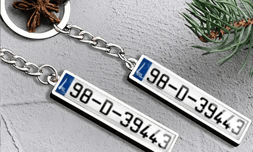 Metal keychain with number plate and flag detail