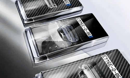 Three car-themed boxes with glossy finish: silver with car, black with cityscape and black car, red with car front